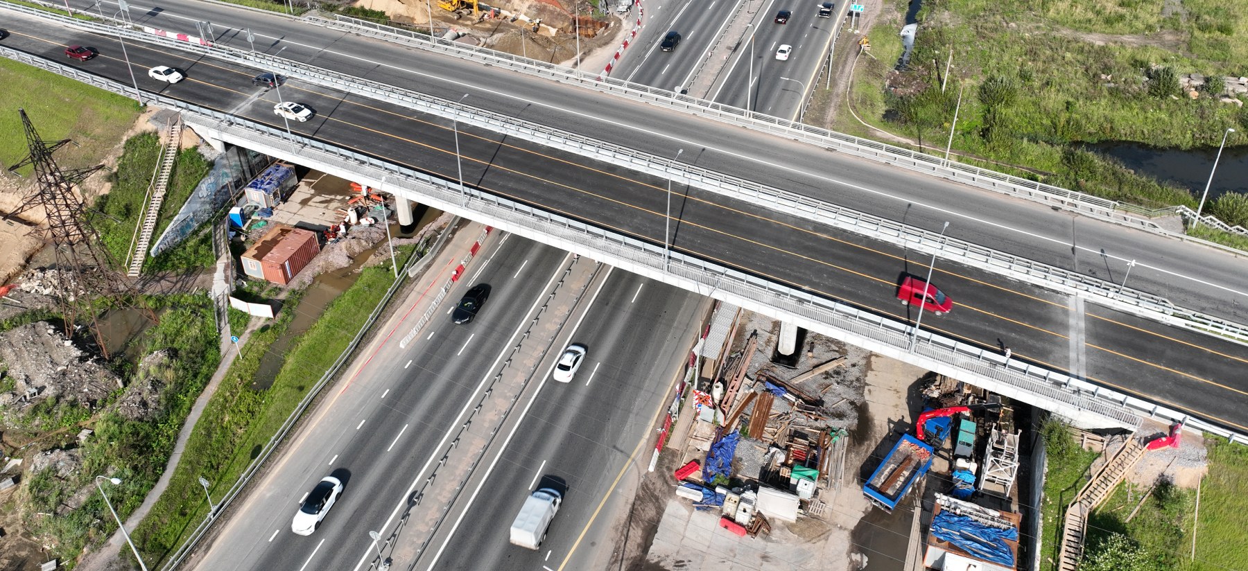 Aerial view of a multi-level road overpass and interchange system along a waterfront