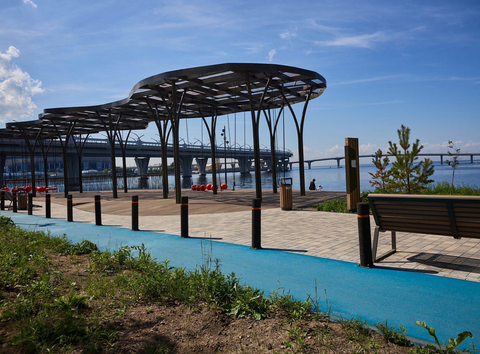 Coloured asphalt walking path in blue at a modern waterfront public realm